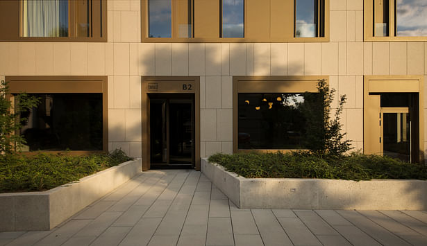 The block is placed in a lush environment with no parking spaces