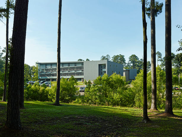The complex is located is a wooded education and research campus. This is a view from the campus loop road.