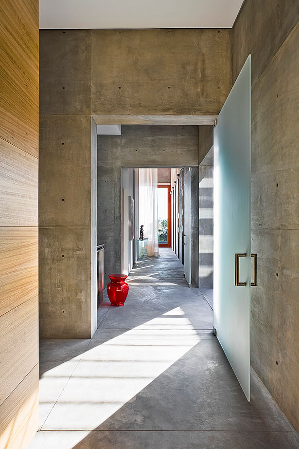 Passages through a hallway within the volumes allow for strong lines of light to permeate.