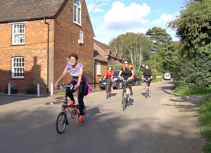 VeloCity team cycling through the village.