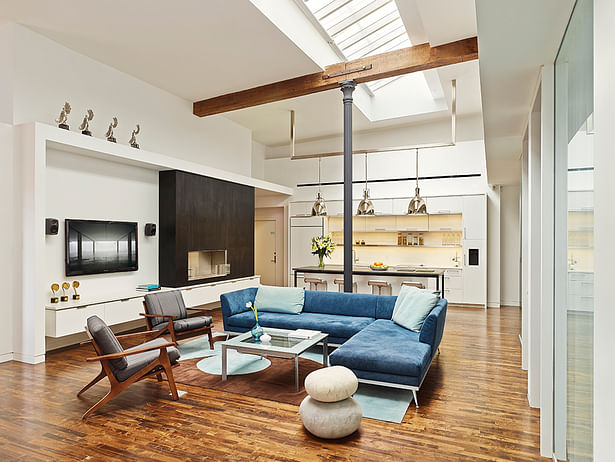 The focal point is the open lounge/kitchen area designed to maximize the loft design, showcasing the building’s original skylights, wood beams, brick walls and cast-iron columns. 