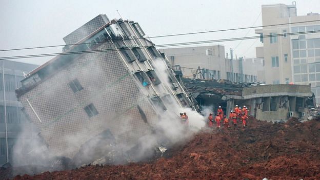 The massive landslide pushed multistory structures over like toy buildings. Dozens of people are still unaccounted for. (Image via bbc.com)