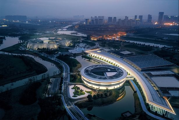 Conference hall and auxiliary hotel glowing at night