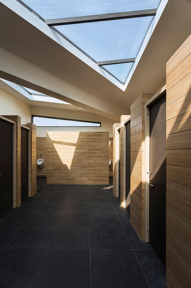The space is lit by triangular Skylight and ventilators Framed by angular origami roof.