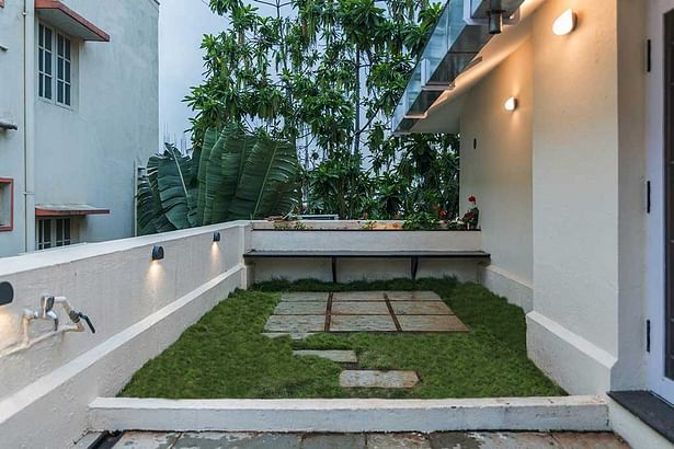 Terrace garden for get together with Granite siting ledge and Stone In-Lay in the grass