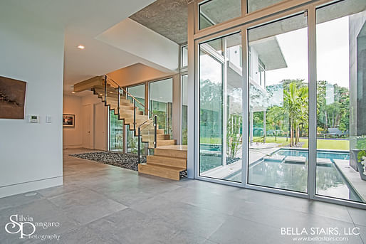 Featuring white oak treads with closed riser and laminated glass inlay railings. Our custom design suited this modernized home perfectly!