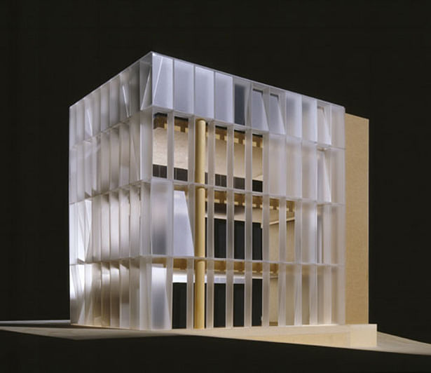 Model view, main facade. Freestanding structural glass facade with translucent & clear LCD panels, programmed to reflect binary digits of 0 and 1 and arranged to signify binary clocks for Tokyo, New York and Vienna. Interior view reflects 'no interior finishes' only concrete and glass. 