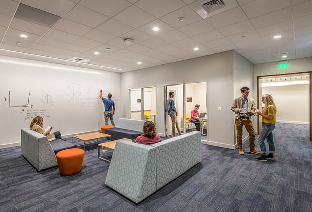 On the second floor, new group study rooms with collaborative tools including digital displays and white boards replace book stacks. A flexible, open study area features a floor-to-ceiling writable wall. Photo credit: Peter Vanderwarker