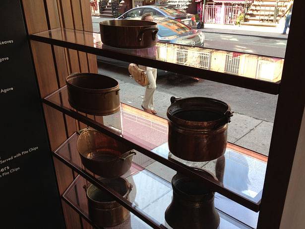 Corten steel t-bar & glass shelves at the vitrine