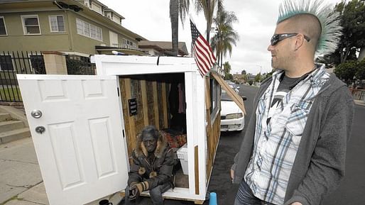 Elvis Summers, right, with a tiny house on wheels he built for Irene "Smokie" McGhee. Photo by Damian Dovarganes / Associated Press.