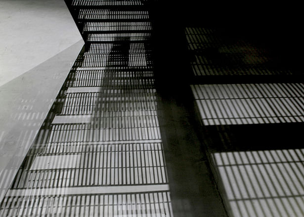shadow of the staircase on the concrete floor