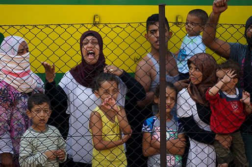 Women and children trying to escape from the conflict in Syria stand at a train station in Budapest. Credit: Wikipedia