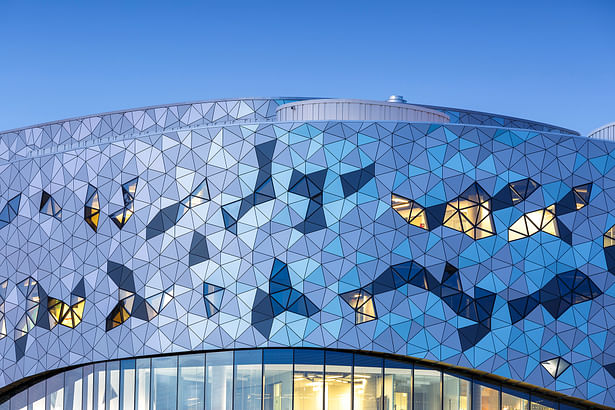 The whimsical abstract facade is grounded in a mathematical, triangle- based algorithm, creating a drifting cloud-like form with changing light and patterns reflected in the interior spaces. Photos by Doublespace Photography.