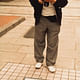 Shimbo Minami, an illustrator and cartoonist, and a member of ROJO, at work documenting the street. c. 1985. Courtesy of Tetsuo Matsuda © The ROJO Society