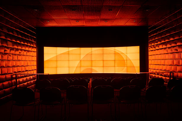 32 plasma screens transform the presentation room into a box of information and light. Glossy black bubble mailers are repurposed as a wall finish and function as an acoustical surface. A place where information technology becomes palpable. 