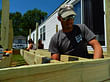 Student Brice Holmes constructs the deck of Beilke’s home.