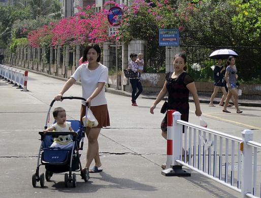 A woman pushes a stroller in a suburb of Zhuhai in southeastern China. (James Pomfret / Reuters)