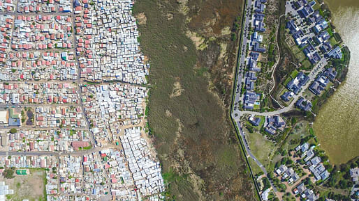 Architecturally segregated communities Masiphumelele (left) and Lake Michelle (right) near Cape Town. Image from the drone photo series "<a href="http://www.unequalscenes.com/">Unequal Scenes</a>" by Johnny Miller.