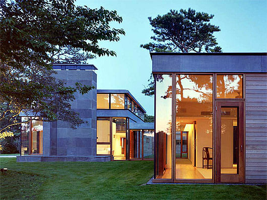 The Rifkind House in Wainscott, NY, a Long Island Modernist triptych pavilion clad in warm cedar siding, balanced with cool New York bluestone. Mahogany floor-to-ceiling window frames and custom-designed cherrywood furniture make the house an inviting and convivial entry into the pantheon of Modernist glass-walled houses. (Image via twbta.com)