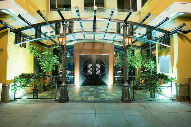 Primary entrance on Colorado Boulevard featuring a curved glass canopy.