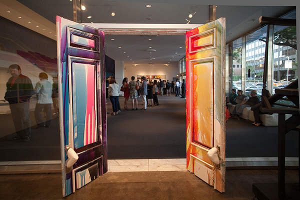 Visitors are welcomed in by the giant colorful McMansion doors that Koumoundouros refurbished surrounded by transparent walls. Photo by Marianne Williams.
