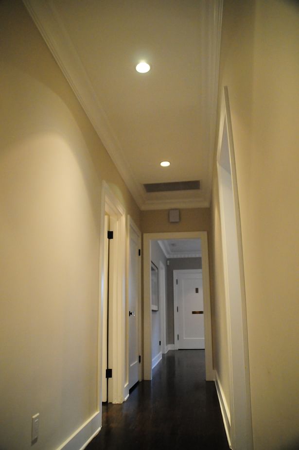 An unnecessary bend in the hallway was re-purposed for a new powder room.