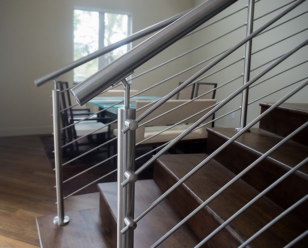 Stainless steel handrails were top mounted to the railings.
