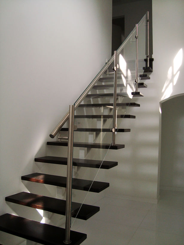 Glass panel railings were anchored to stainless steel glass clamps on each stainless steel post.