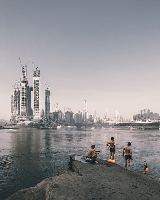 Sense of Place — Swimmers on the riverside opposite the construction of Raffles City Chongqing, China by Safdie Architects. Photographer: Zhu Wenqiao