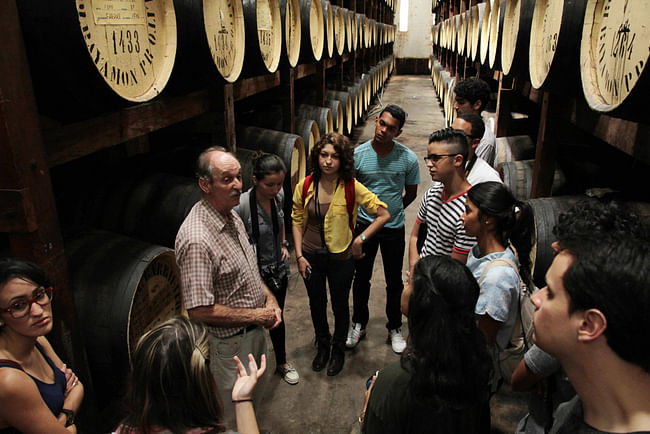 Participants on a tour of a rum facility. Image via 'Play With Your Food'.