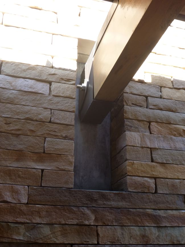 How the wooden beams meet the stone wall