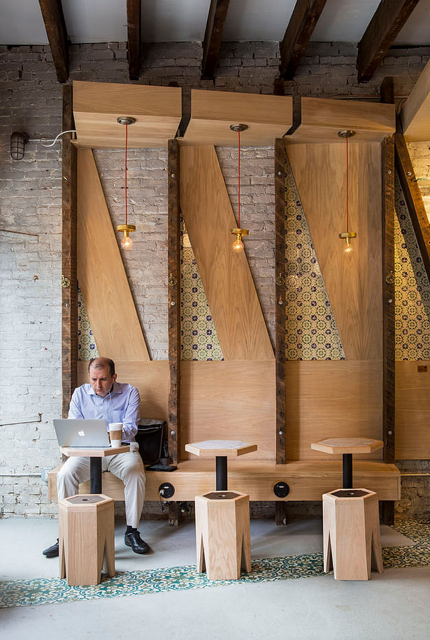 Successively angled wax finished white oak paneling define the seating banquet.