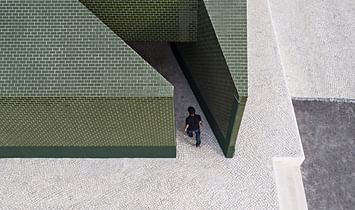 m2.senos creates a public restroom coated in green ceramic tile for a cemetery in Portugal