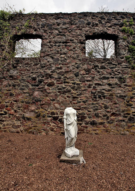 Inside the burned shell of the hay barn is a setting of marble sculptures by Suzanne DeChillo/The New York Times 