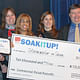 “Stormwater reStore” Team of Christopher Gubeno, Urban Engineers, Inc. (far right) and Johanna Phelps, Matthew Nielsen Landscape Architects (second from right) accept award for Commercial: Retail Retrofit category © CG Lawrence Photography (Gregory Clarke)