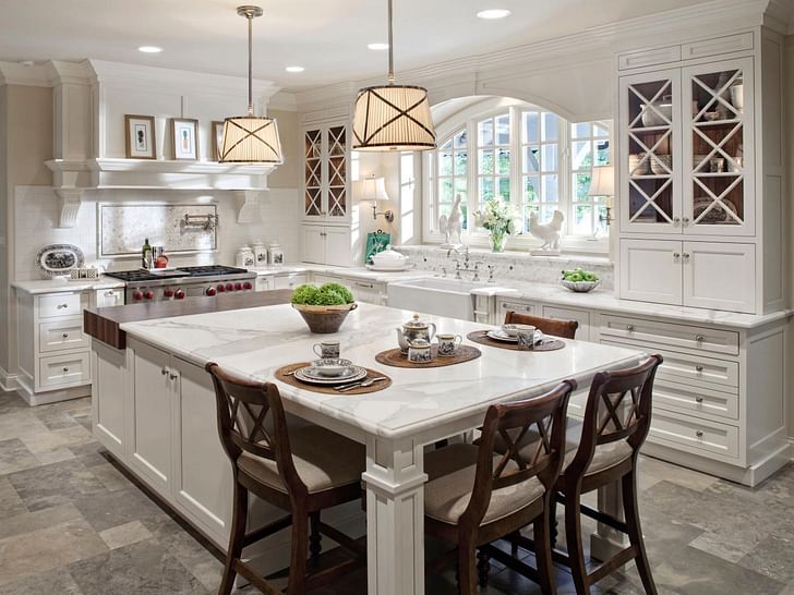 A kitchen featuring an island with seating for four. Photo by Tina Muller for Drury Design.