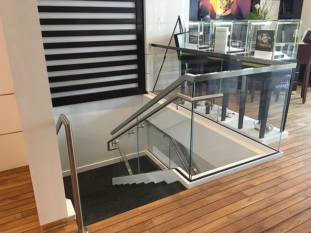 Second floor glass guardrails also feature a top mounted stainless steel cap rail.