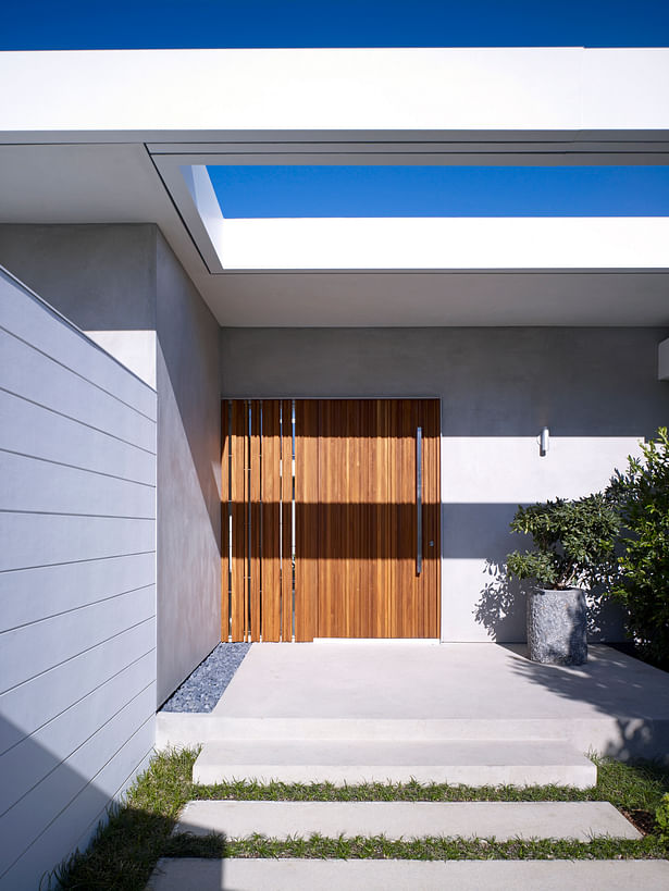 An open-air skylight and custom teak entry door