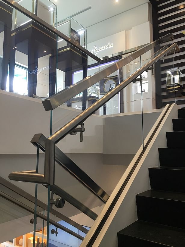 Rounded Stainless Steel Handrail Mounted Directly onto Glass Panels.