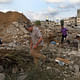 Palestinian men search for bodies among the ruins of a building. Credit: Tyler Hicks / NY Times
