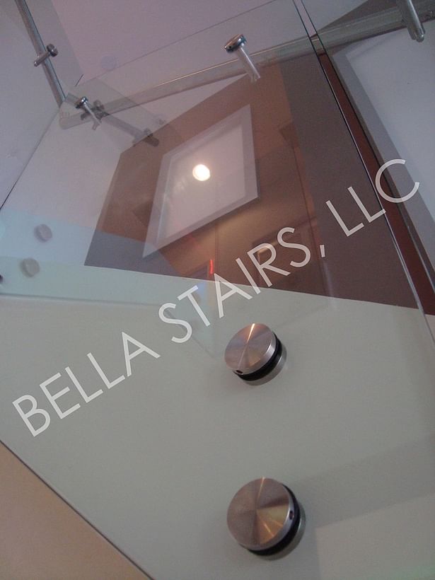 Stainless steel standoffs were side mounted to anchor the new glass railing.