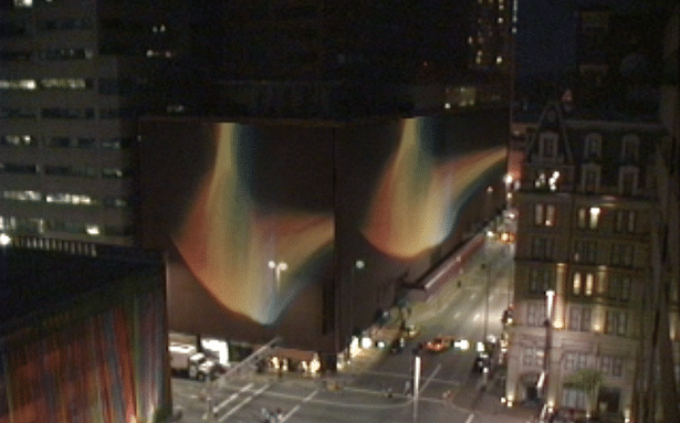 video still of Jim Davis films projected onto building