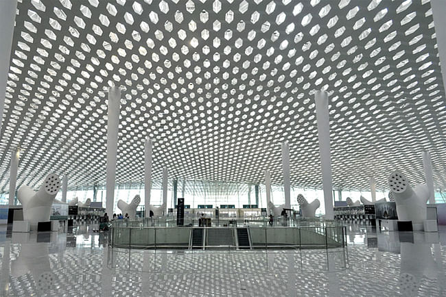 Honeycomb shaped roof panels punctuate the roof to allow natural light to filter through. Image © Studio Fuksas
