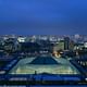 The glass canopy illuminated at night Image credit: Foster + Partners