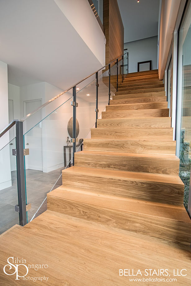 White Oak Wood Treads, Laminated Glass Inlay Railings, Custom Painted Steel Posts, & a Top-mounted Stainless Steel Handrail.