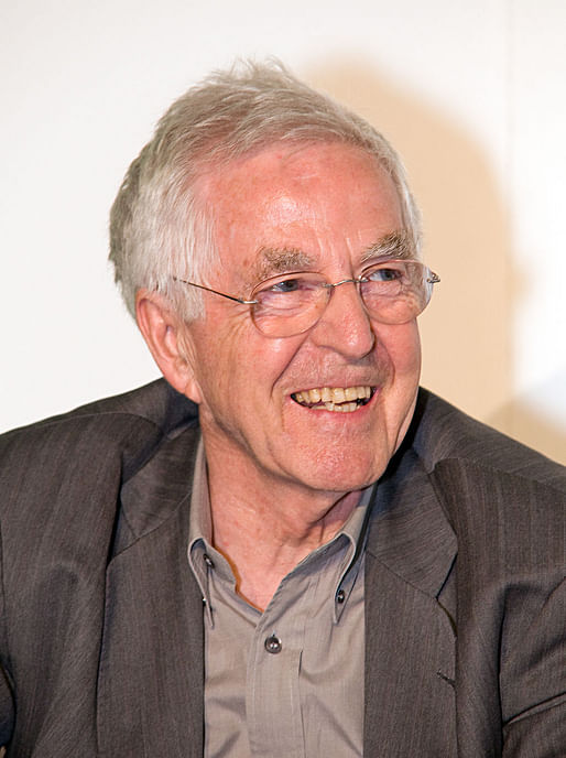 An image via wikimedia.org. Oddly, the caption reads, "A smiling caucasian male with grey hair, blue eyes, in front of a white background. He is wearing a light grey shirt and dark grey jacket."