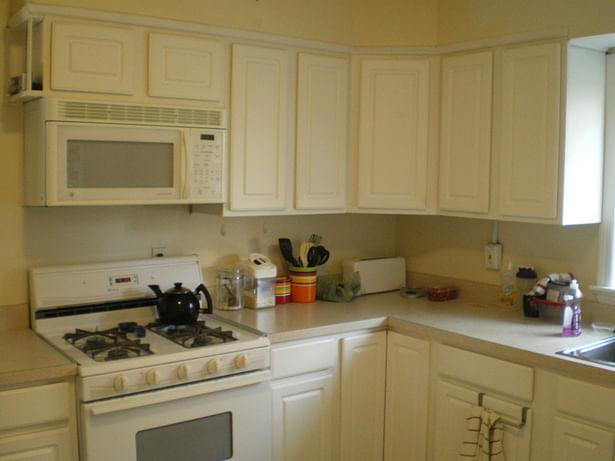 Kitchen BEFORE renovation - all white melamine, Formica, vinyl flooring and bad carpentry
