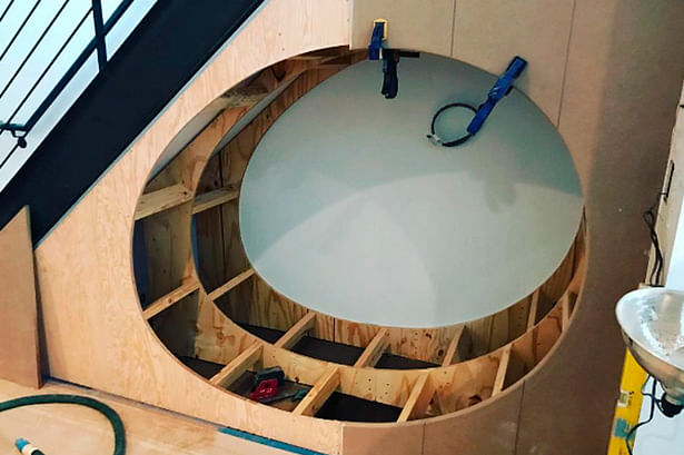 Construction progress on a cozy under-stair play nook for the clients' young children.