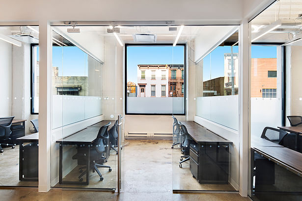 The private offices are kept minimal and super streamlined. This afford community members a clean slate against which to set up their own work environments. All desks are custom designed solid slab tables, designed for this client. 