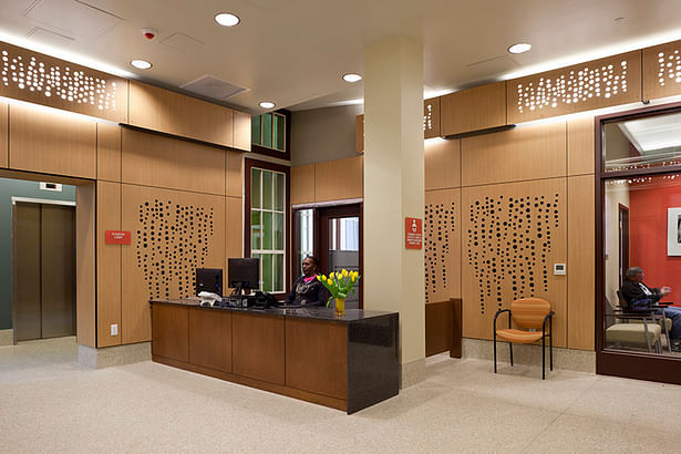 Reception area with custom perforated paneling